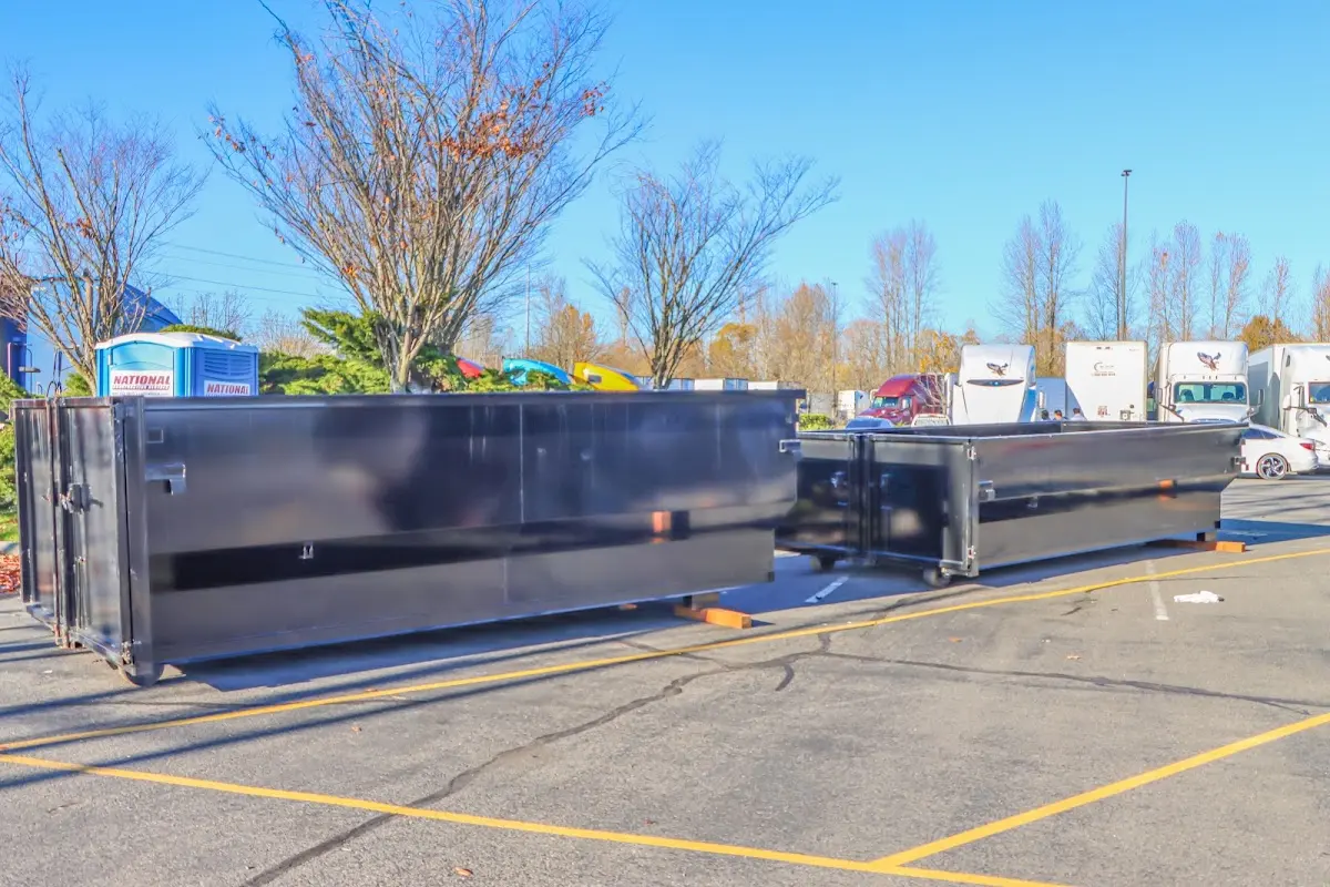Professional dumpster rental service with roll-off container on residential driveway in Price